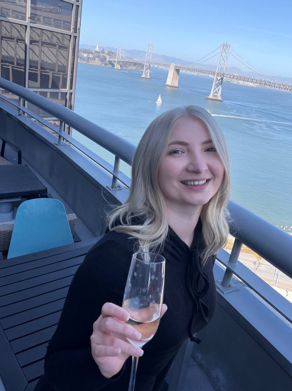 Blonde client portrait with the Bay Bridge behind her